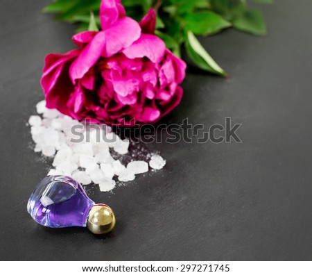 peony essence and bath flower with peony flower in the background