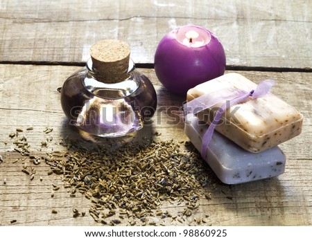 lavender essential oil and dried flowers with candle and soap