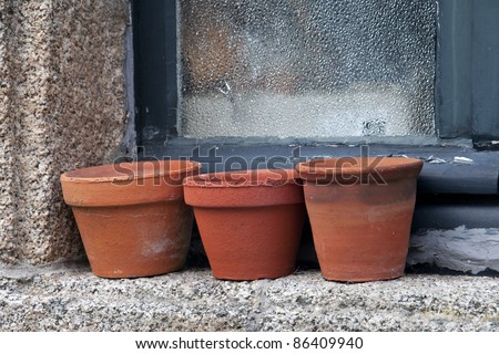 terracotta plant pots on a window ledge