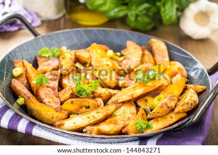 tasty fried potato slices with herbs.