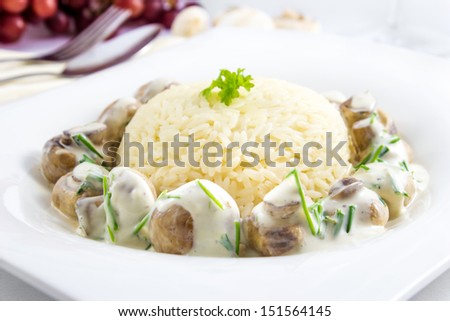 Fresh pan-fried mushrooms with rice and cream sauce with chives