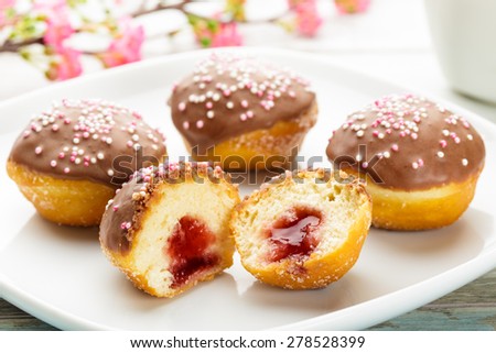 Petite sufganiyah with chocolate topping and marmelade filling.