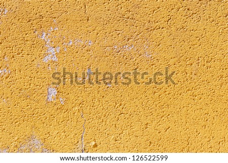 Abstract closeup of a plastered front with orange paint