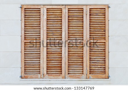 Detail of weathered brown shutters of a spanish house