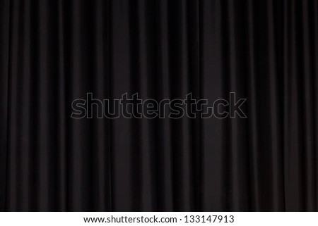 Detail of a black closed curtain in a theater