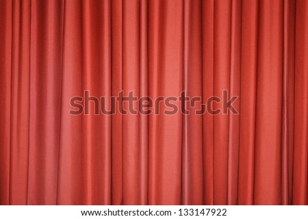 Detail of a red closed curtain in a theater