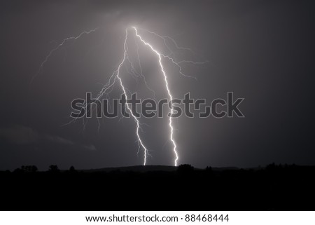 Lightning strike within a thunderstorm at night