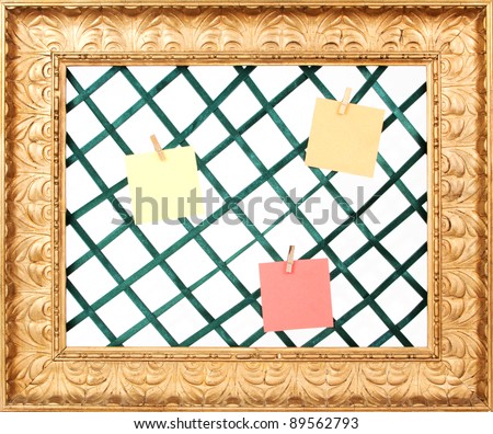 Golden picture frame with green holders and notes and a white background