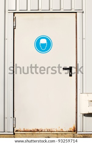 Entry door of a factory with a sign