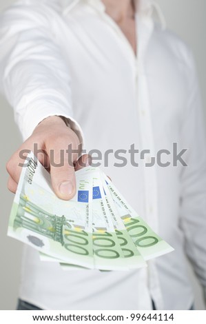 man holding a stack of cash in hand
