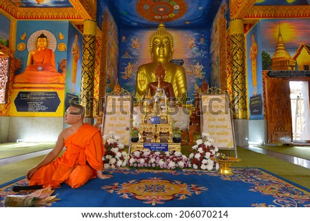 PHRAE, THAILAND - FEBRUARY 13: Buddhist monk praying at Wat Luang on February 13, 2014 in Phrae, Thailand.