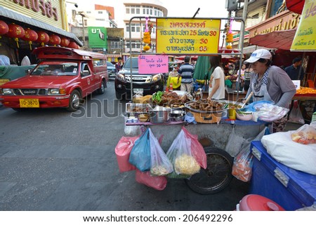 CHIANG MAI, THAILAND - FEBRUARY 15: Woman selling food at a street stall on February 15, 2014 in Chiang Mai, Thailand.