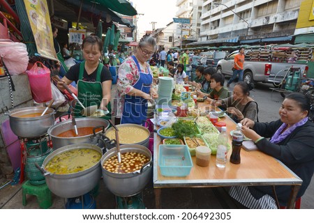 CHIANG MAI, THAILAND - FEBRUARY 15: Women selling food at a street stall on February 15, 2014 in Chiang Mai, Thailand.