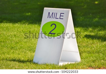 mile marker sign on grass