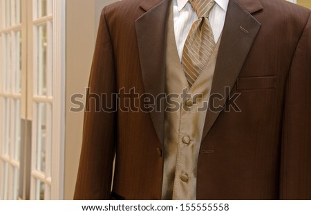 elegant brown tuxedo with satin vest and silk tie
