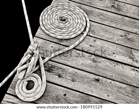 nautical rope knotted around a dock cleat