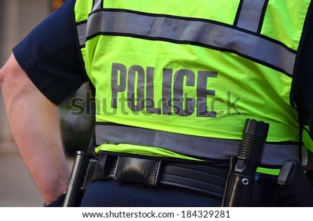 policeman wearing a neon safety vest
