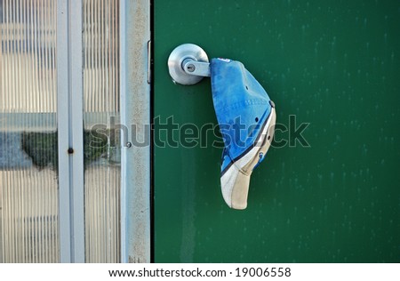 sweat stained ball cap on door handle