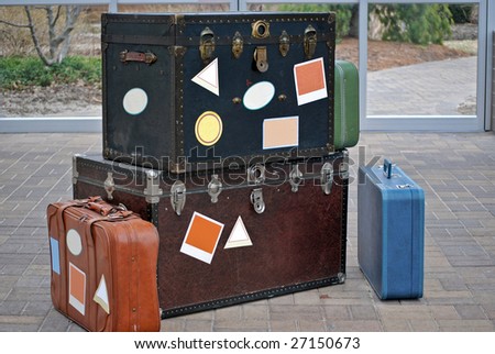 trunk and suitcases with travel stickers