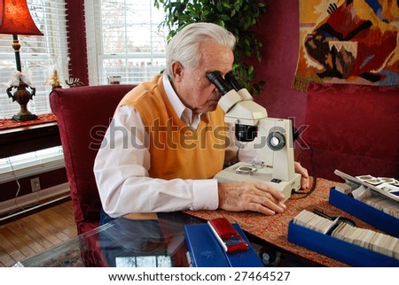 man viewing an old coin