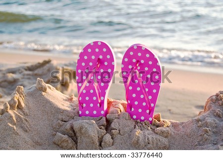 flip flops in the sand. dot flip-flops in sand