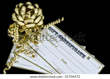 gold bow and ribbon on holiday gift certificates