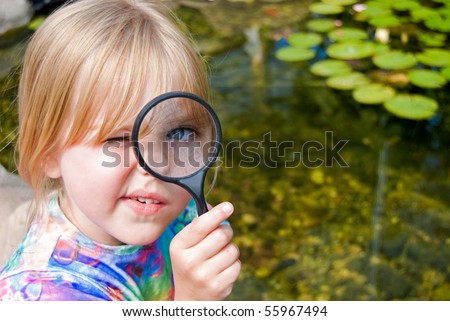 little girl with magnifying glass