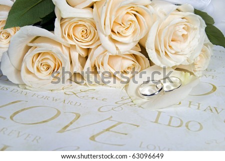 stock photo wedding rings on rose petal with bouquet