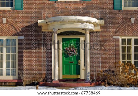 christmas wreath on bright green door