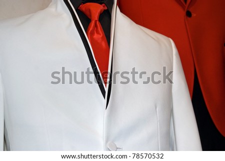 red satin tie accenting a white tuxedo