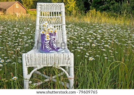 daisy bouquet in purple sneakers on wicker chair