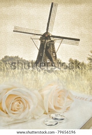 stock photo old windmill with wedding rings and roses on holy bible