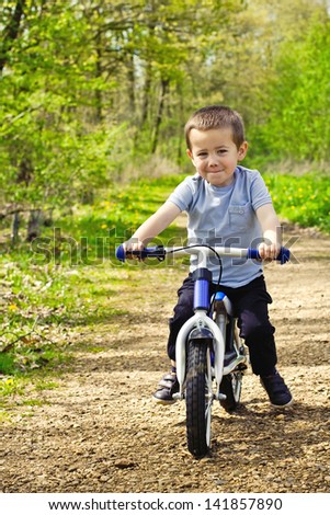 Little boy cycling his bicycle outdoor