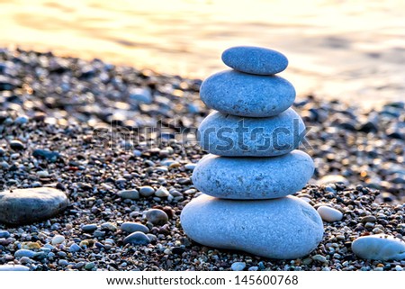 Zen-like stone pyramid on the beach at the daybreak