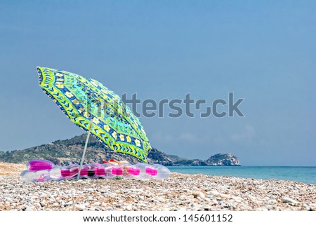 Sunshade and air bed on the beach