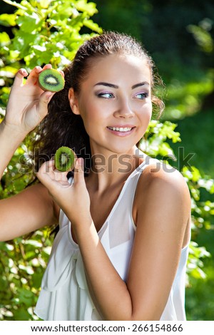 Young woman with with kiwi, healthy food concept, skin care and beauty, vitamins and minerals