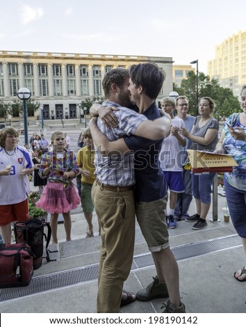 MADISON, WISCONSIN USA - JUNE 6: A gay couple getting married on the steps of the City County Building after a judge struck down Wisconsin\'s gay marriage ban on Friday June 6, 2014 in Madison, WI