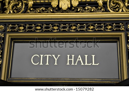 A city hall sign with ornate architectural details