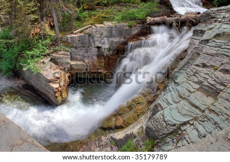 A panoramic view of a waterfall in Glacier National Park, Montana