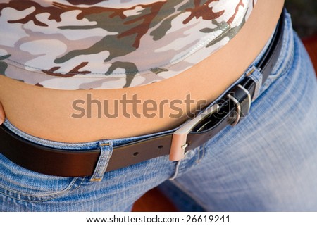 Young girl dressed jeans with leather belt
