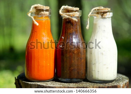 three bottles of homemade sauces