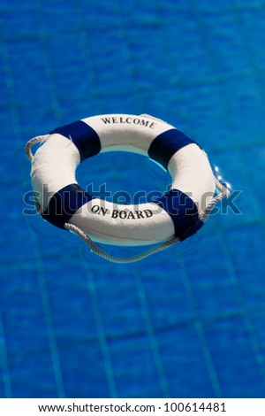 Life buoy floating in the outdoor swimming pool