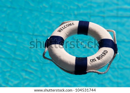 Life buoy floating in the outdoor swimming pool