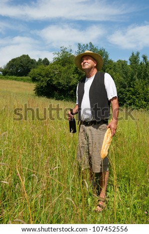 Typical French man in nature with bread and wine