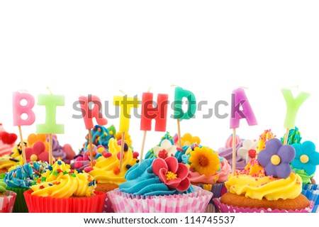 Colorful birthday cupcakes with candles isolated over white background