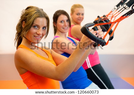 Girls are doing suspension training in the sports club