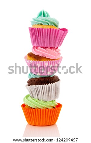 colorful stacked cupcakes with butter cream isolated over white background