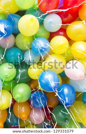 Many colorful balloons with ribbons