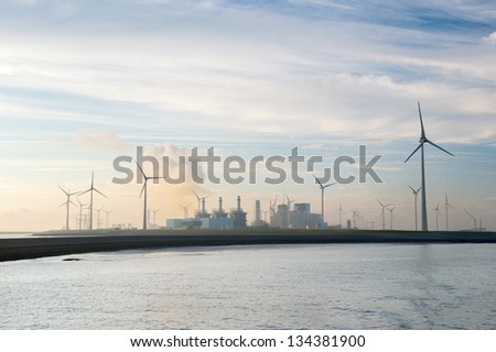 Industrial harbor with factories and wind turbines in Holland