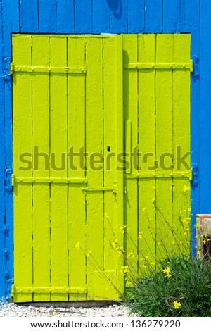 Colorful wooden doors from cabins for oyster fishermen at Chateau de Oleron